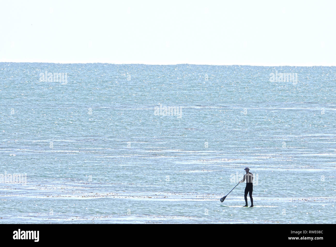 20th February, 2019 Capitola, CA, USA   Paddle surfer strokes is board on calm Pacific Ocean off Capitola, California USA Stock Photo