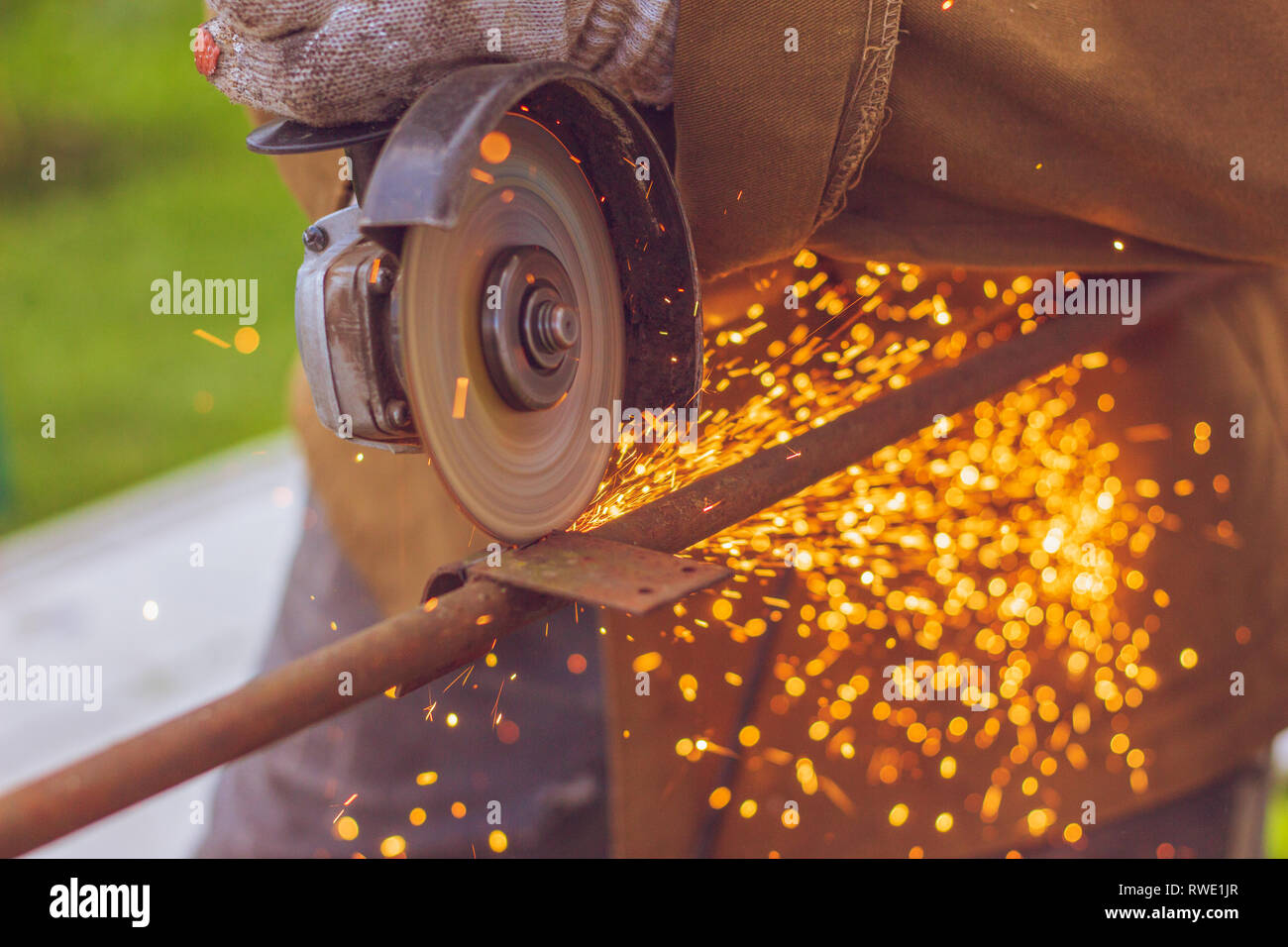 Cutting blade grinder closeup with flying sparks from the metal during