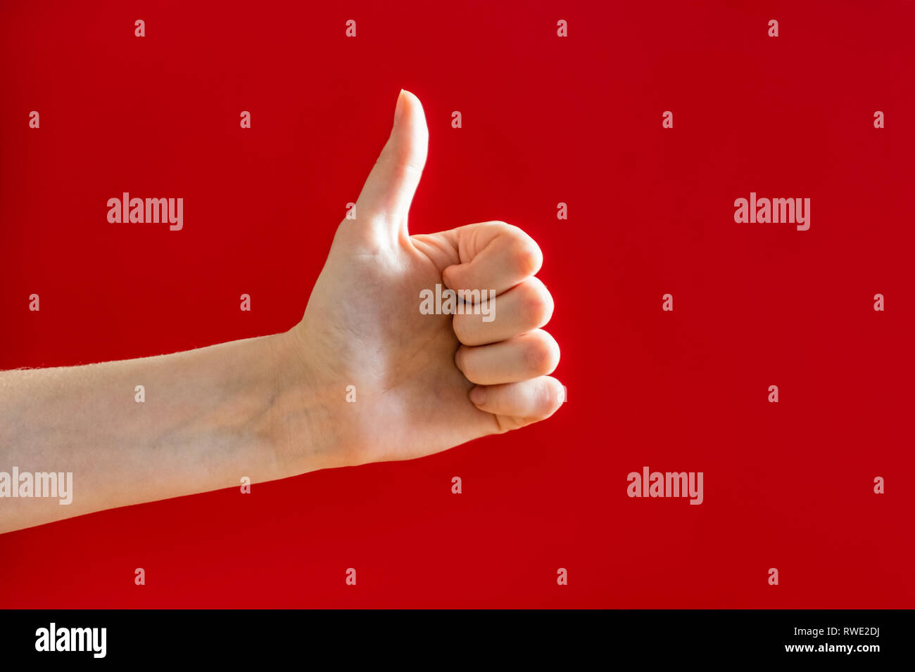 Thumbs up, approval gesture concept. Hand showing a "thumb up" sign in