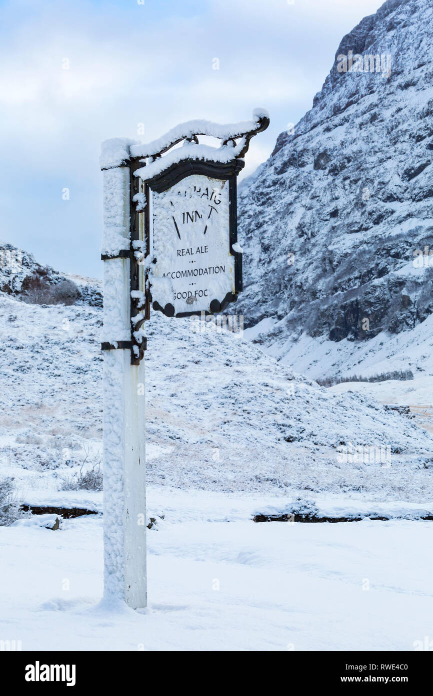 sign for Clachaig Inn with snow covered scenery, Glencoe, Argyll & Bute ...