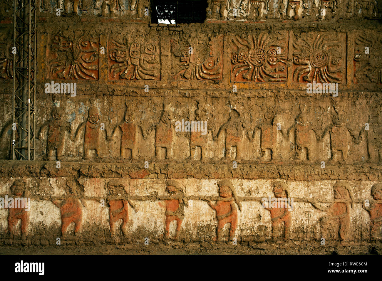 Richly decorated external wall with human figures in the ceremonial halls. Huacas del Sol y de la Luna archeological site. Trujillo, Peru. Jul 2018 Stock Photo