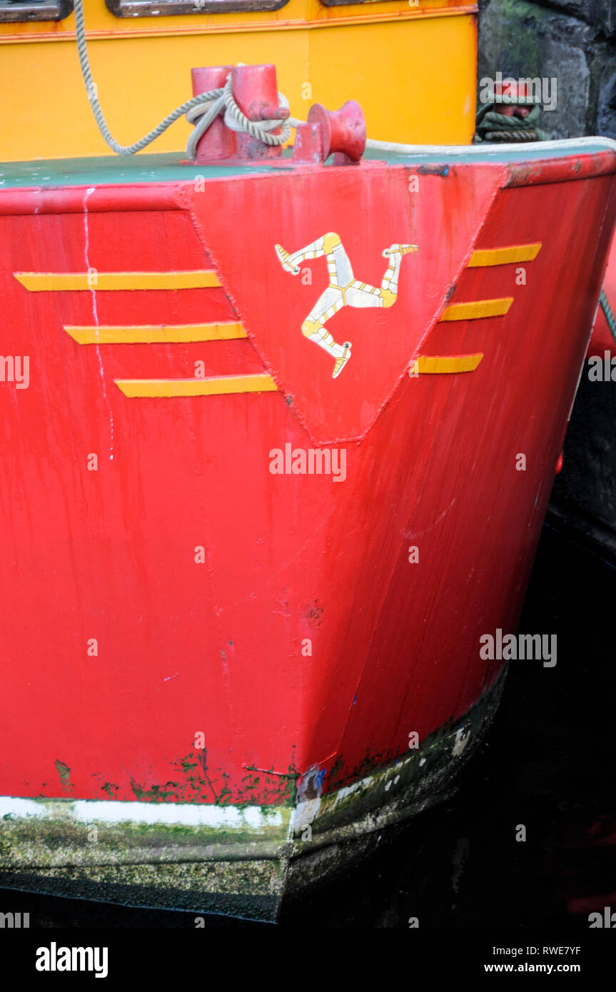 Logo of three legs, symbol of the Isle of Man on the bow of a Manx fishing trawler moored in the