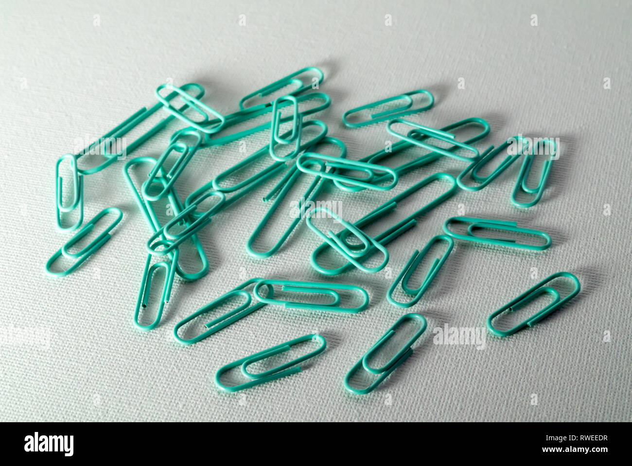 A Studio Photograph of Turquoise Paperclips Stock Photo