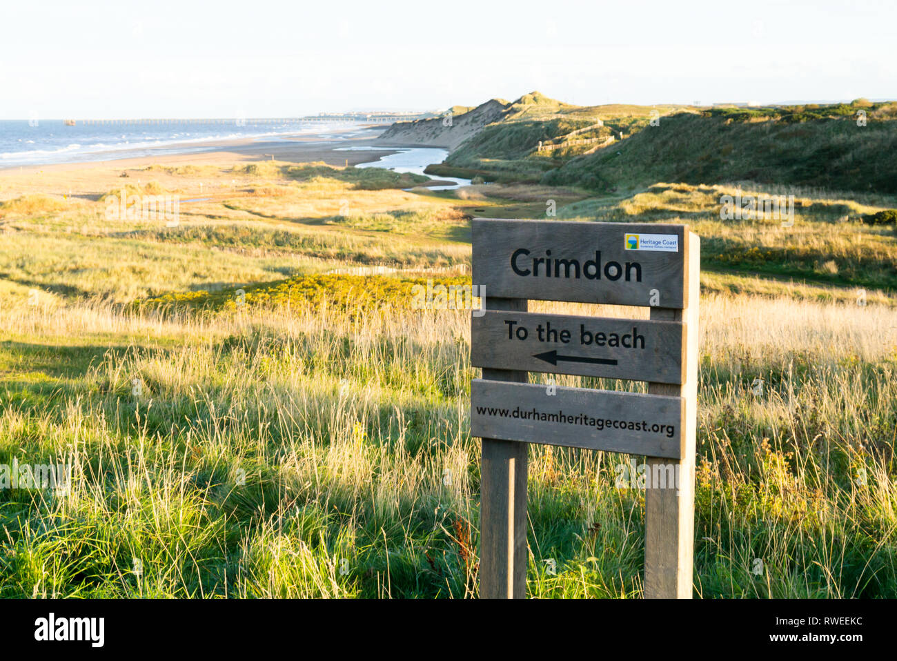 A View of the Coastline at Crimdon Dene with a Signpost for Crimdon Beach Stock Photo