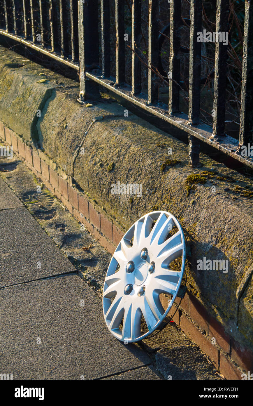 A Lost Wheel Trim Left at the Side of the Road Stock Photo