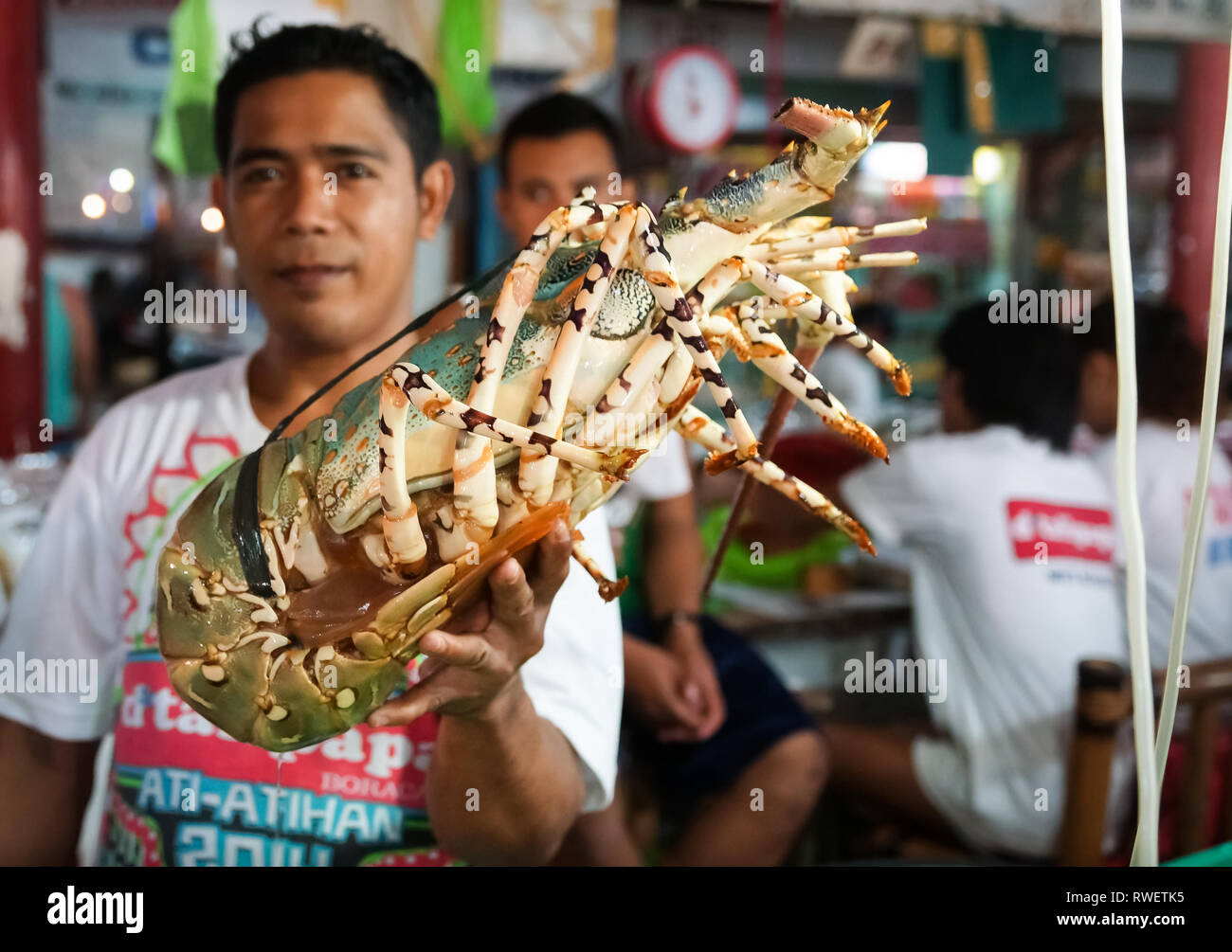 Large Colorful Lobster Held by vendor in Seafood Market Boracay