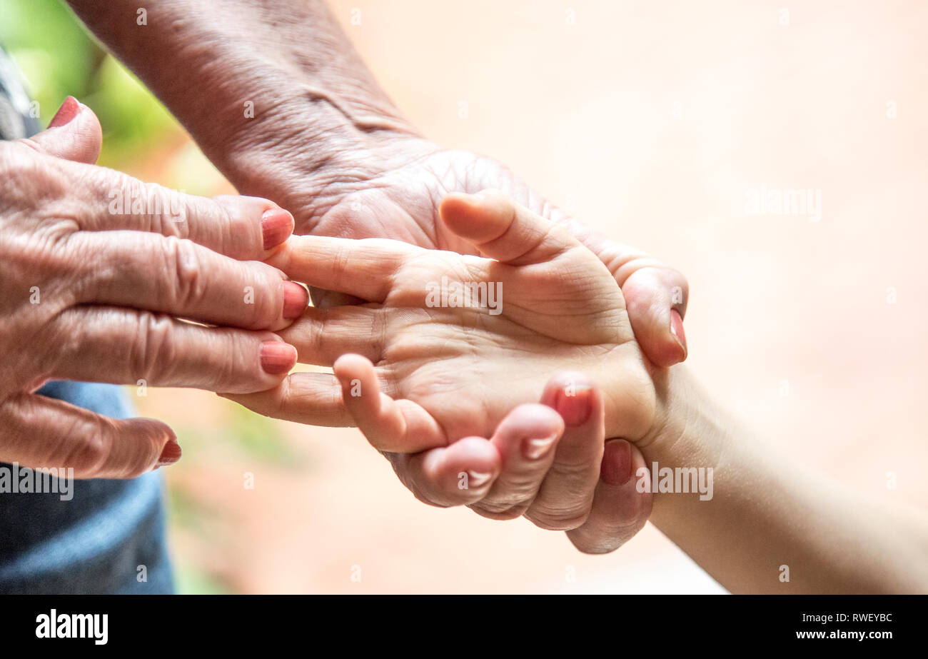hand of an elderly woman holding a child's hand Stock Photo - Alamy