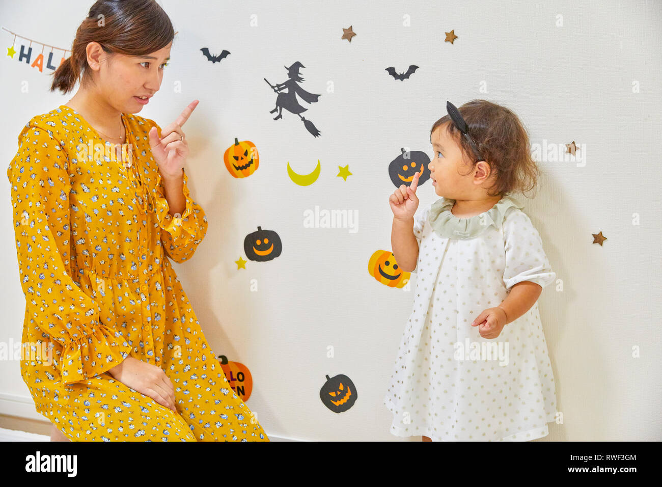 Japanese child and mother getting ready for Halloween Stock Photo