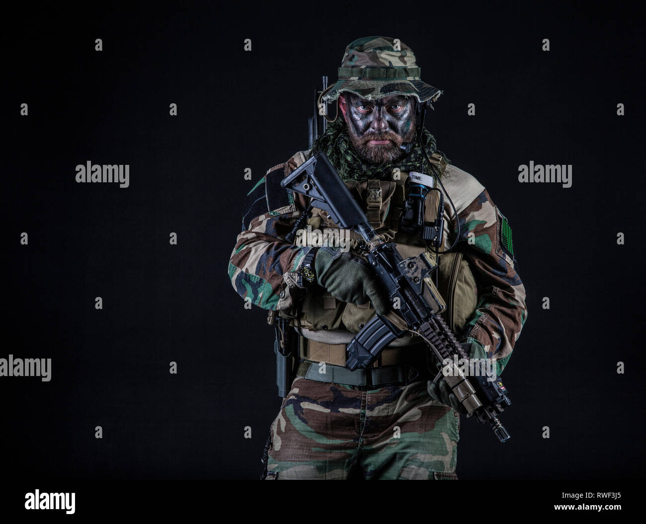 A U.S. special forces soldier in camouflage uniform holding weapon. Stock Photo