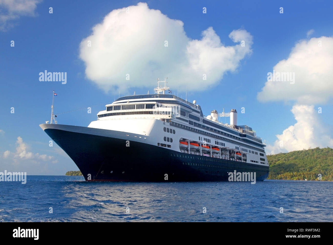 World voyage cruise ship at anchor off the beautiful tropical island of Bora Bora, French Polynesia. Stock Photo