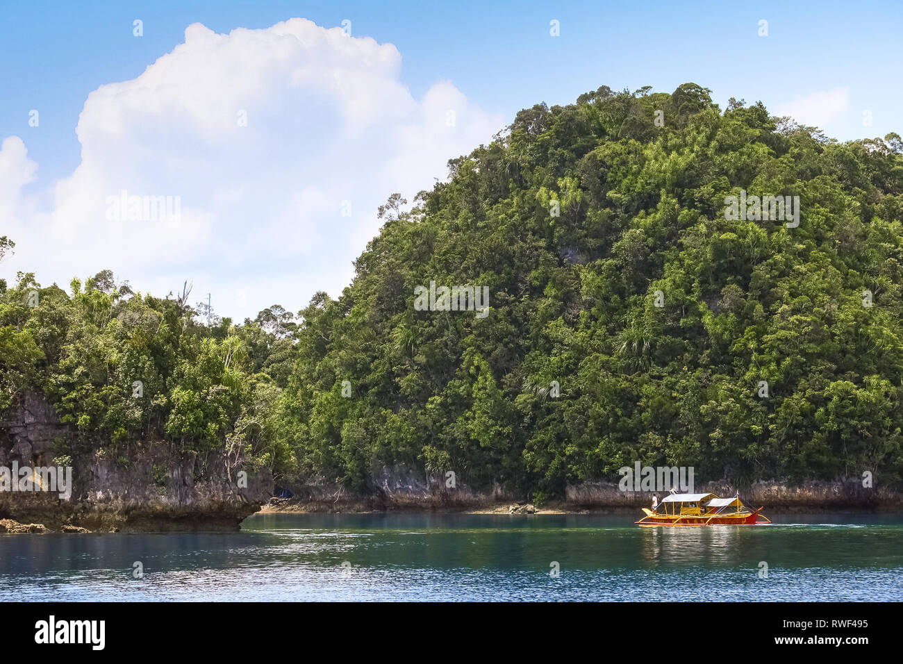 Exotic Cliffs and Colorful Tour Boat - Sohoton Cove, Siargao, Philippines Stock Photo