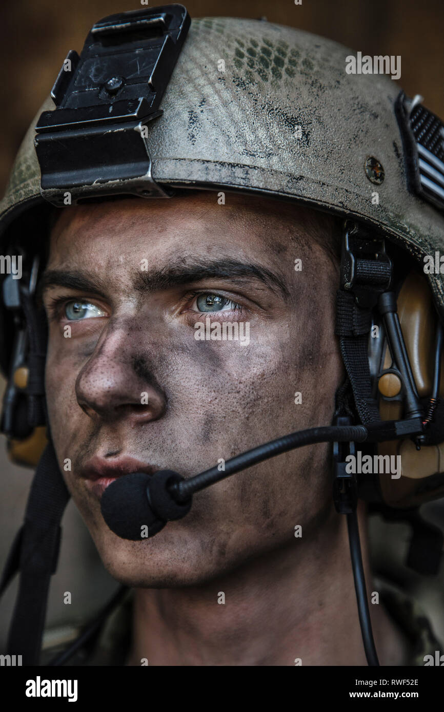 Close-up portrait of a young U.S. Army Ranger wearing combat helmt ...