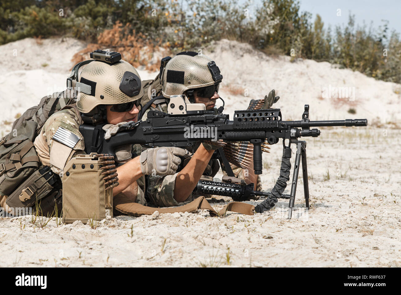 Members of U.S. Army Rangers machine gun crew during a fight in the