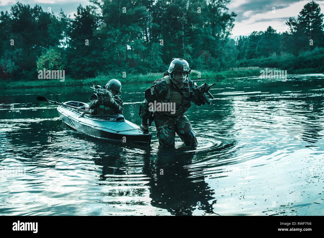 Pair of soldiers disembarking from their military kayak under the cover