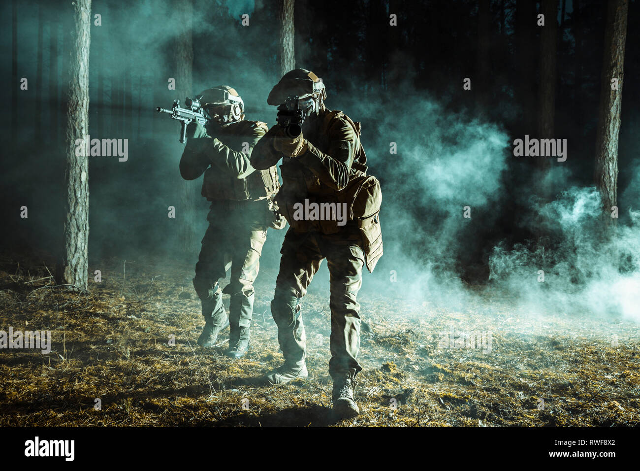 Backlit Photo Of Soldiers Moving Amongst The Smoke At Night In The Forest Stock Photo Alamy