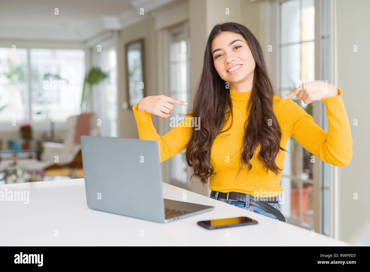 Young woman using computer laptop looking confident with smile on face ...