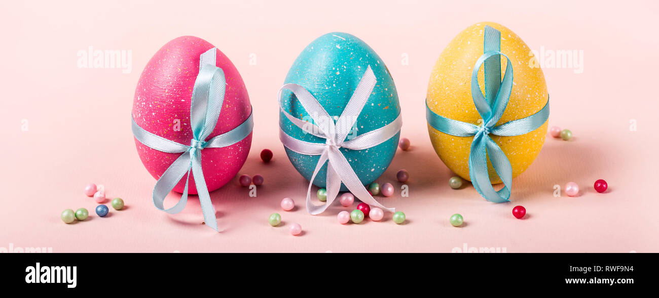 Decorated eggs stand in a row. Easter concept, banner format. Stock Photo