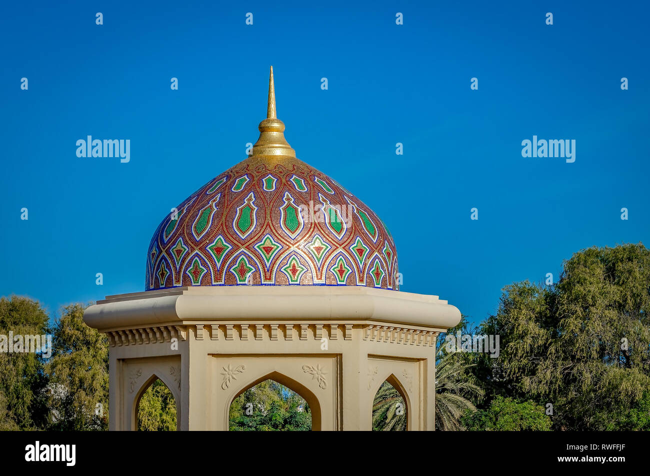 Artistic Gazebo Dome with a pointer against a clear blue sky. Middle Eastern Architecture from Oman. Stock Photo