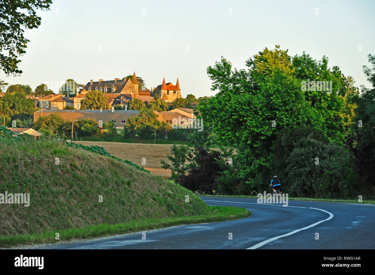 Eymet Road and village of Lauzun, Lot-et-Garonne Department, Aquitaine, France Stock Photo