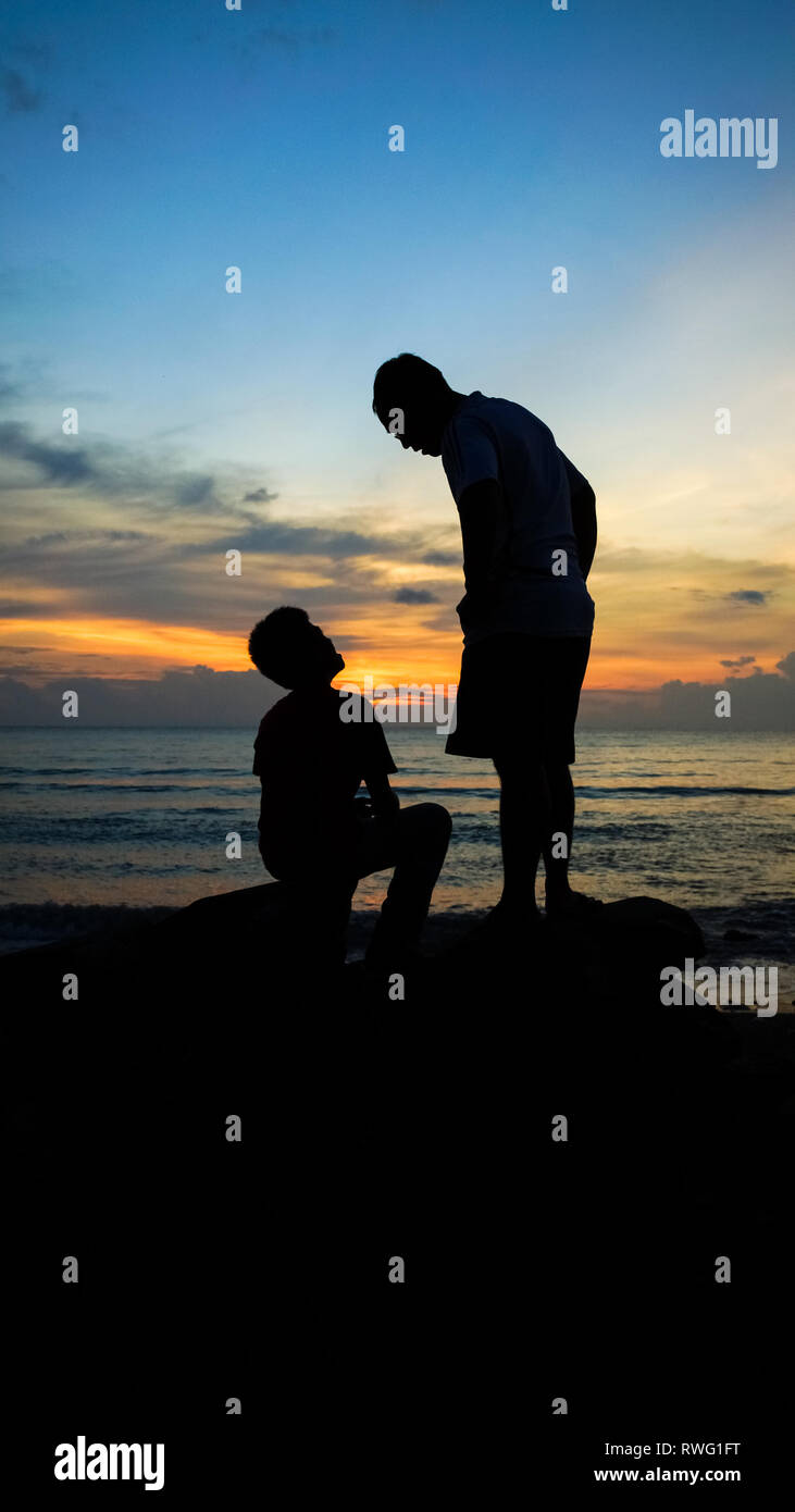 Father Teaching Son and Bonding During Beach Sunset - Batangas, Philippines Stock Photo
