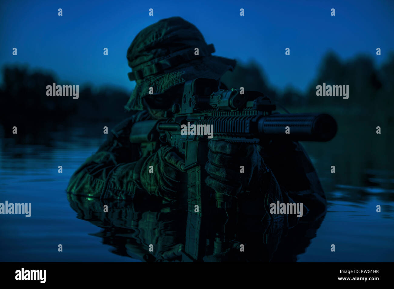 Special forces soldier with rifle in action during a river raid in the ...