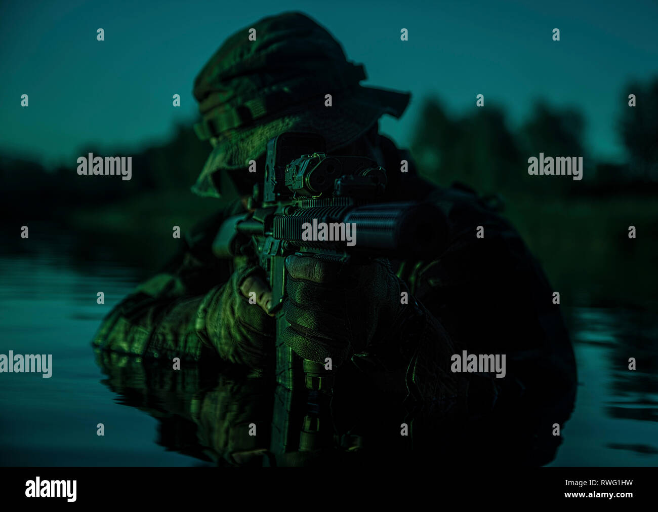 Special forces soldier with rifle in action during a river raid in the ...