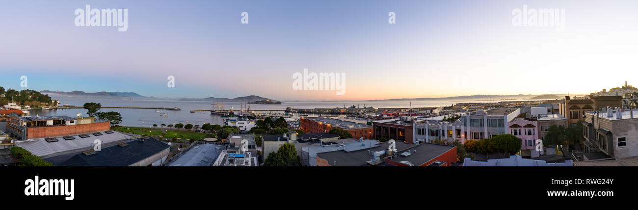 Panoramic image featuring North Point neighborhood, Alcatraz, Fishermans Wharf and San Francisco bay at daybreak Stock Photo