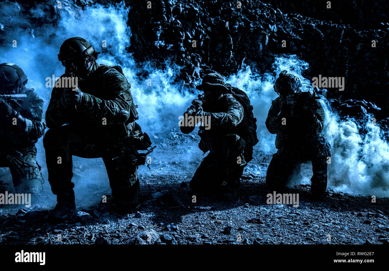 Squad of special forces under the cover of darkness. Stock Photo