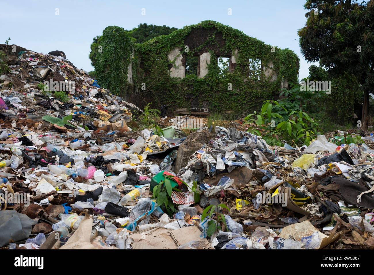 Trash piles up around a building ruin in Freetown, Sierra Leone. Stock Photo