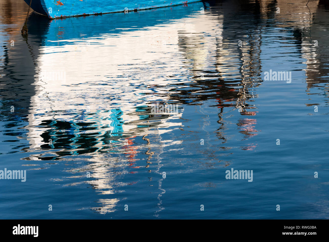 Reflection of a fishing boat on the sea Stock Photo