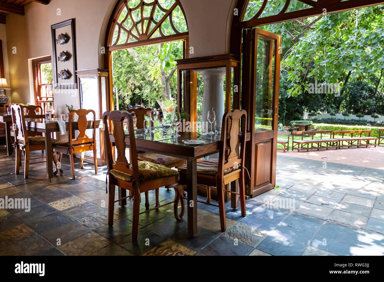 Pretoria, South Africa, 11 February - 2019: Interior view of hotel restaurant area with view to gardens outside. Stock Photo