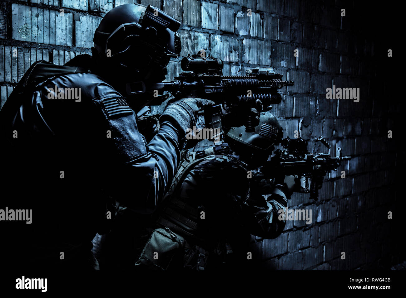 Pair of soldiers in action under the cover of darkness. Stock Photo