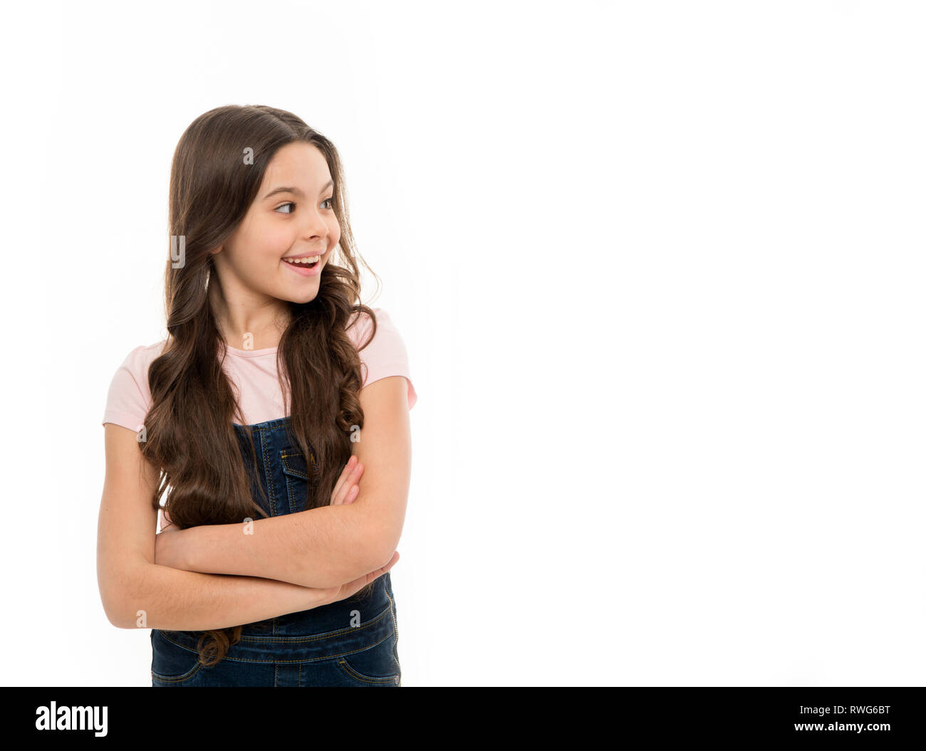Going glamorous. Happy little girl with loose hairstyle. Little child with long locks of hair. Small model with brunette hair in beauty salon. Pretty girl happy smiling with new hairstyle, copy space Going glamorous. Happy little girl with loose hairstyle. Little child with long locks of hair. Small model with brunette hair in beauty salon. Pretty girl happy smiling with new hairstyle, copy space