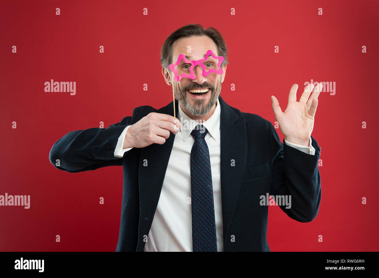 Cheerful businessman in party photo booth props. Guy enjoying party ...