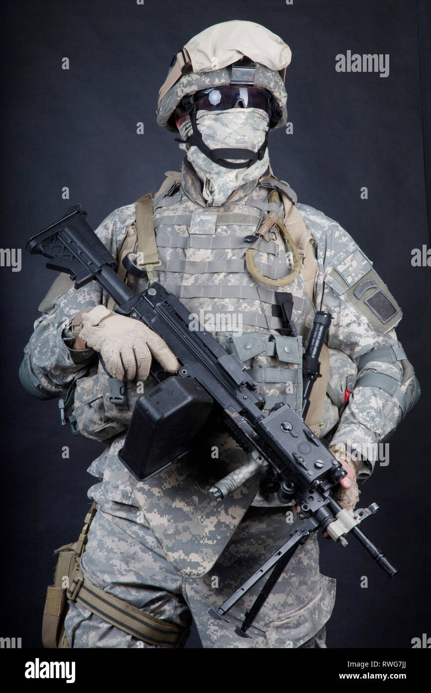 U.S. Marine posing with a light machine gun equipped with infrared ...