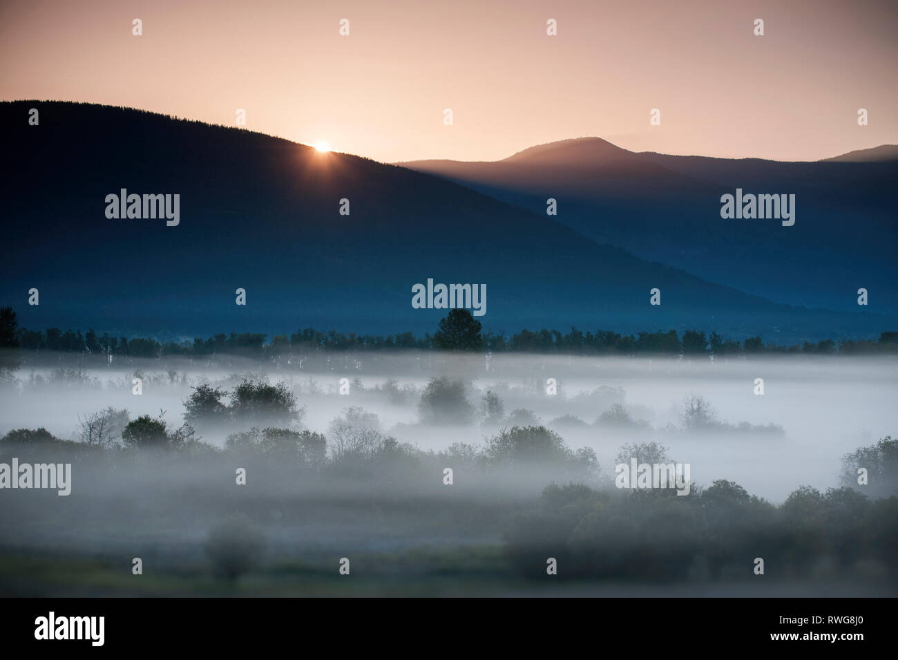 Sunrise and fog over Creston Valley, BC, Canada Stock Photo Alamy