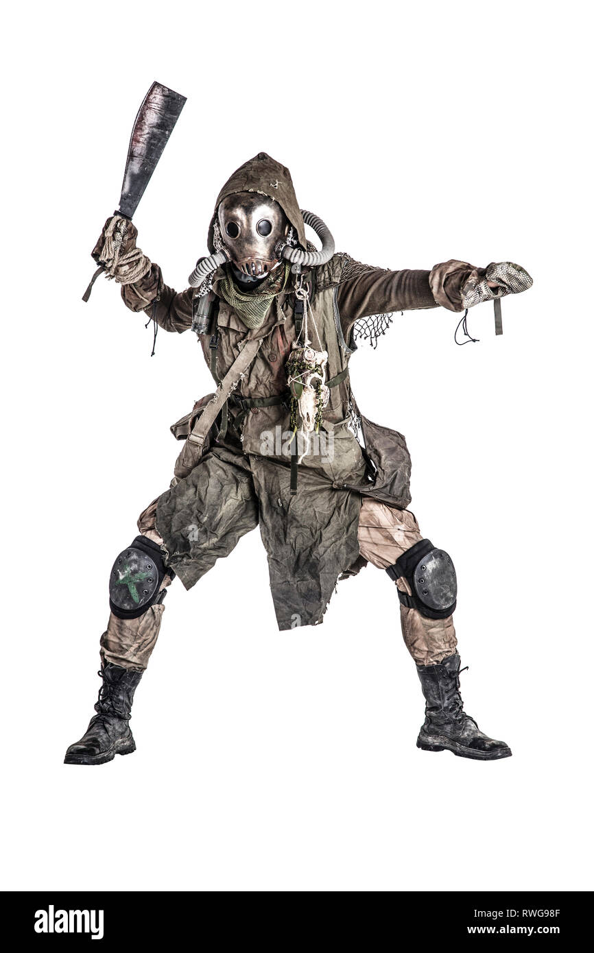 Evil creature wearing tattered rags and gas mask, holding a blood-stained machete. Stock Photo