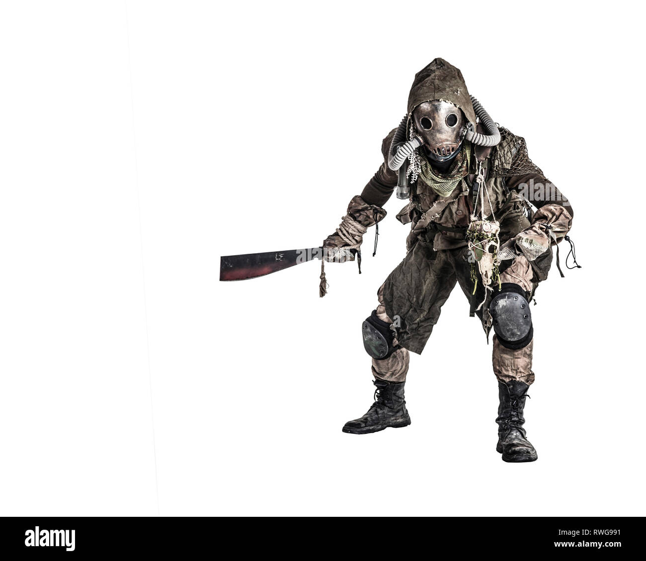 Evil creature wearing tattered rags and gas mask, holding a blood-stained machete. Stock Photo