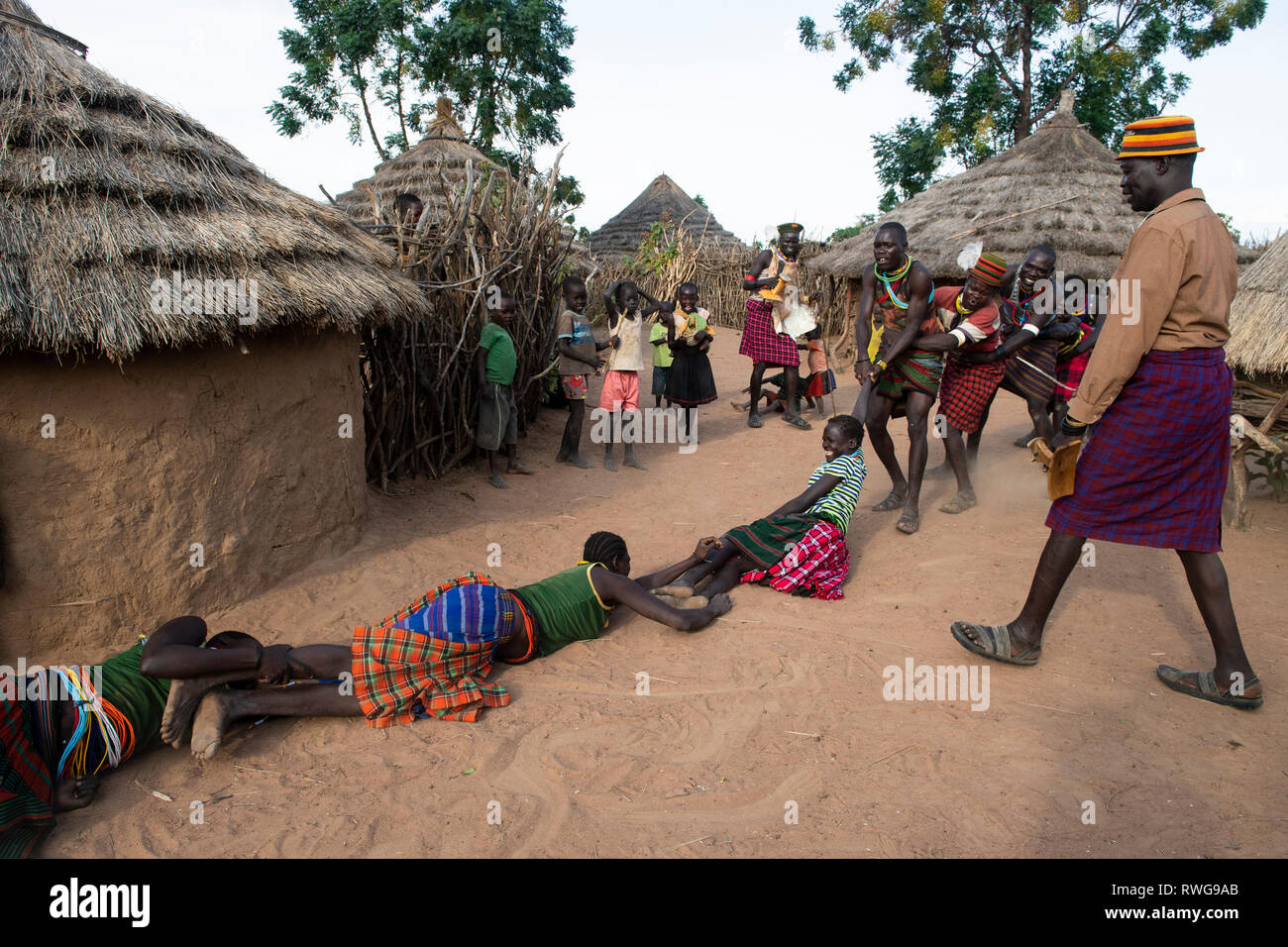 Traditional game playing in a Karamojong village, northern Uganda Stock Photo
