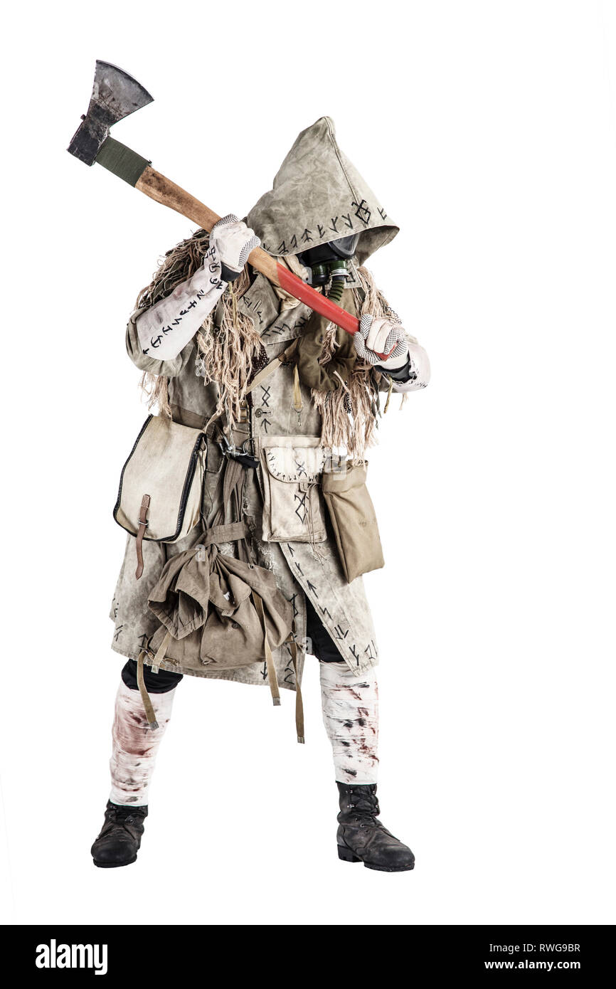 Post apocalypse survivor in gas mask and ragged clothes beckoning with axe in hand. Stock Photo