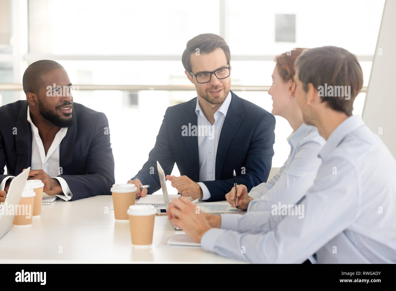 Diverse millennial business people negotiating in the conference room Stock Photo
