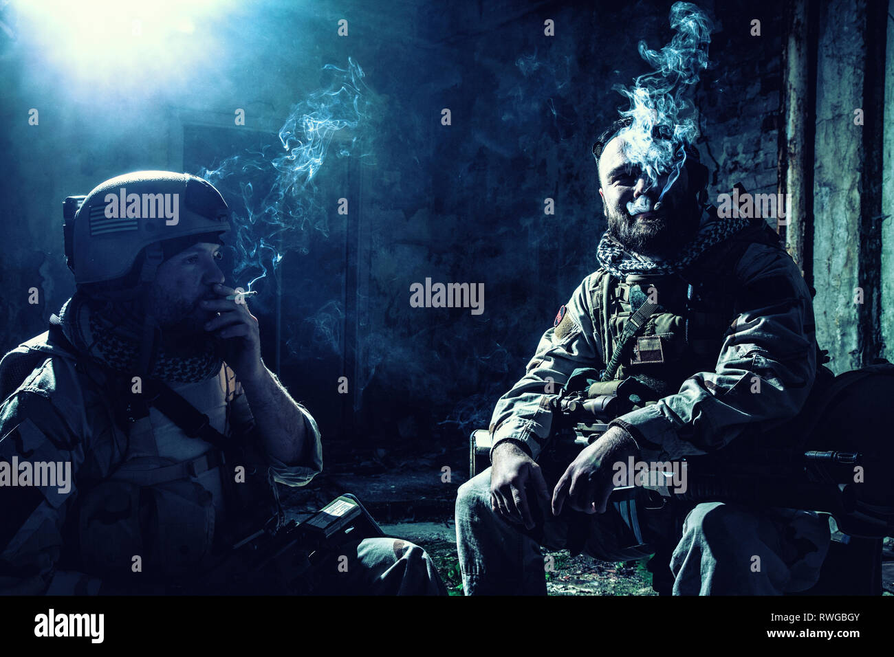 Tired soldiers smoking cigarettes in an abandoned building after a hard  fought battle Stock Photo - Alamy
