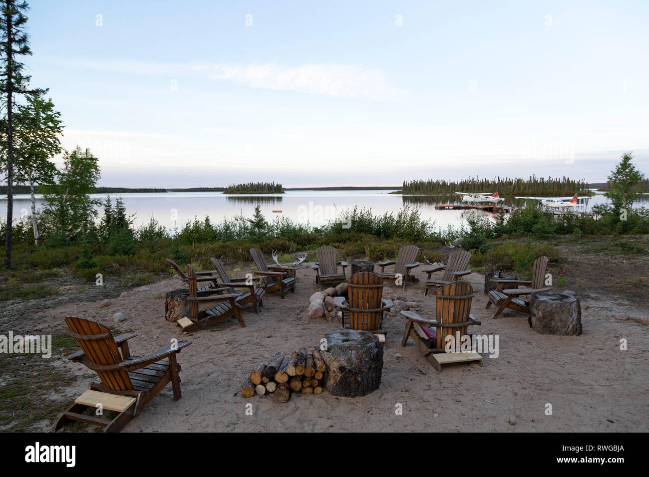 Seats around the campfire at Gangler's Lodge in Manitoba, Canada. The lodge opertaes fishing and adventure tours on the remote region. Stock Photo