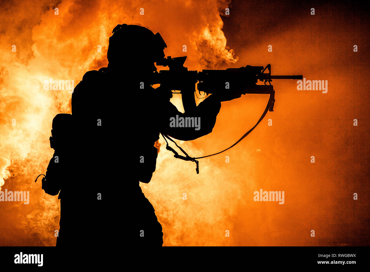 Silhouette of modern infantry soldier standing with assault rifle on ...