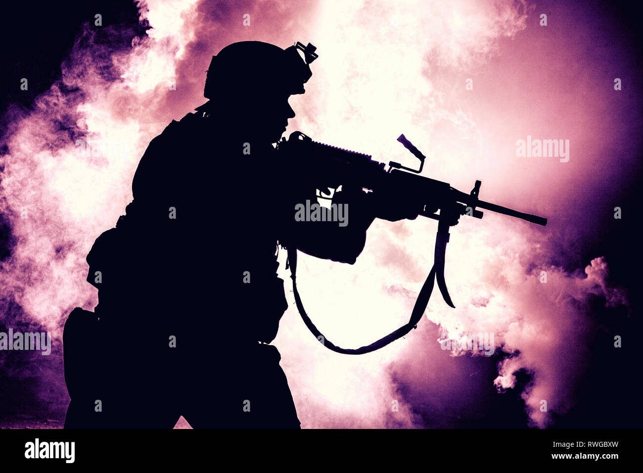 Silhouette of modern infantry soldier standing with assault rifle on ...
