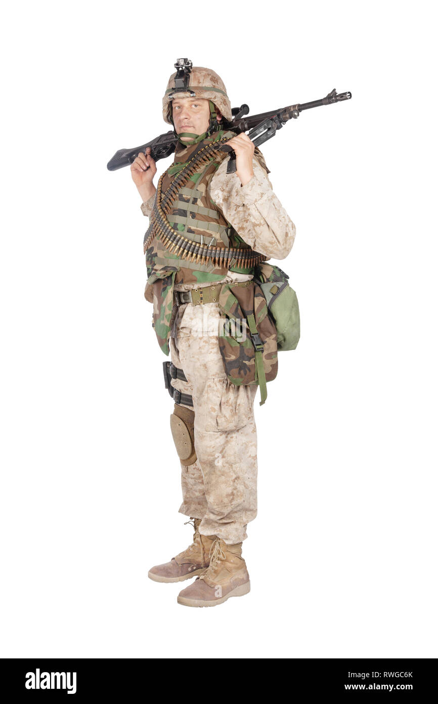 Soldier in camouflage combat uniform standing with machine gun Stock ...