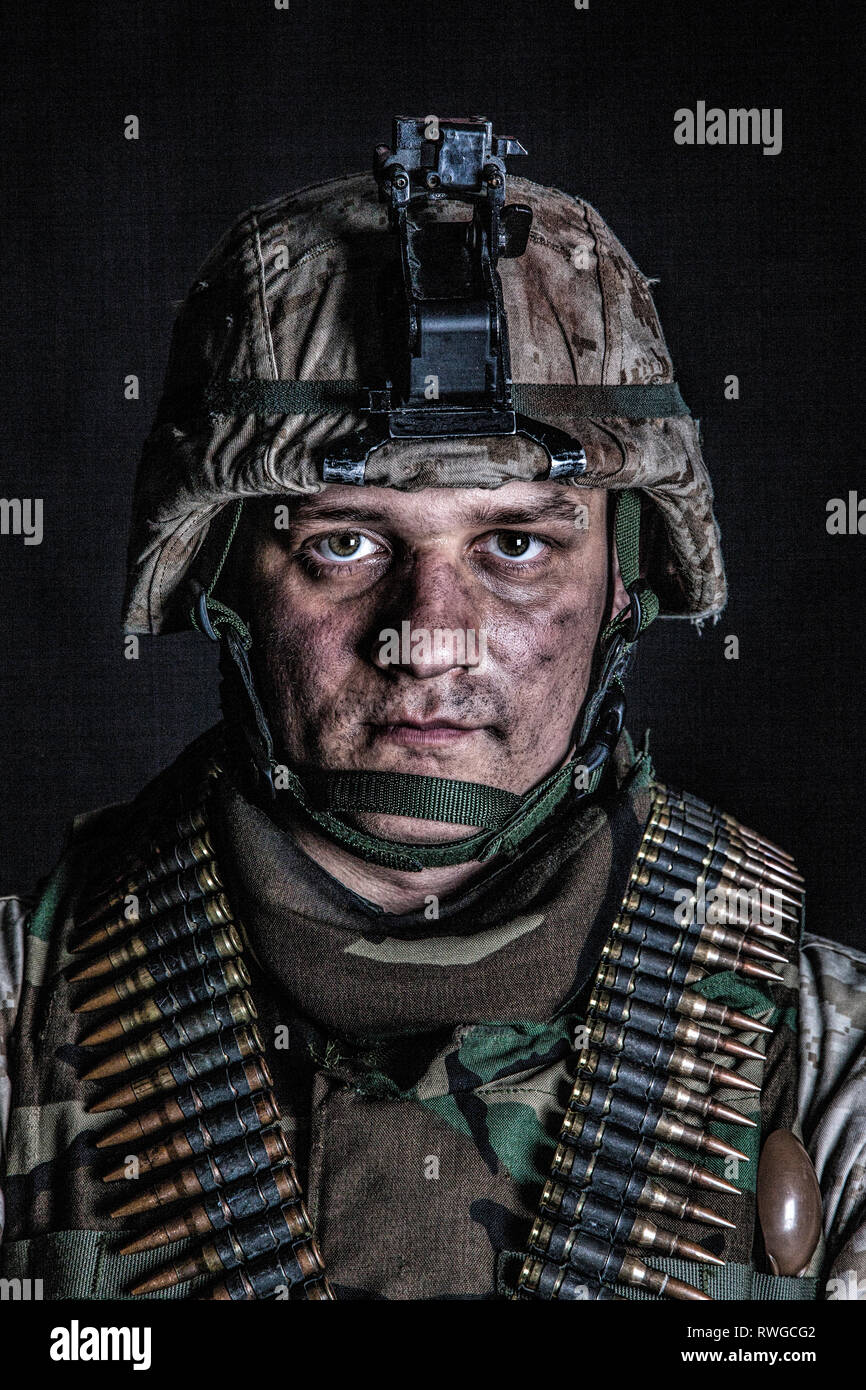 Machine gunner portrait with ammunition belts across chest, studio shot. Stock Photo