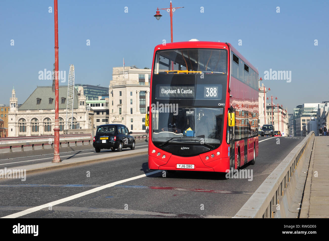 Red Double-decker bus crossing Blackfriars road bridge over the River Thames, London, England, UK Stock Photo