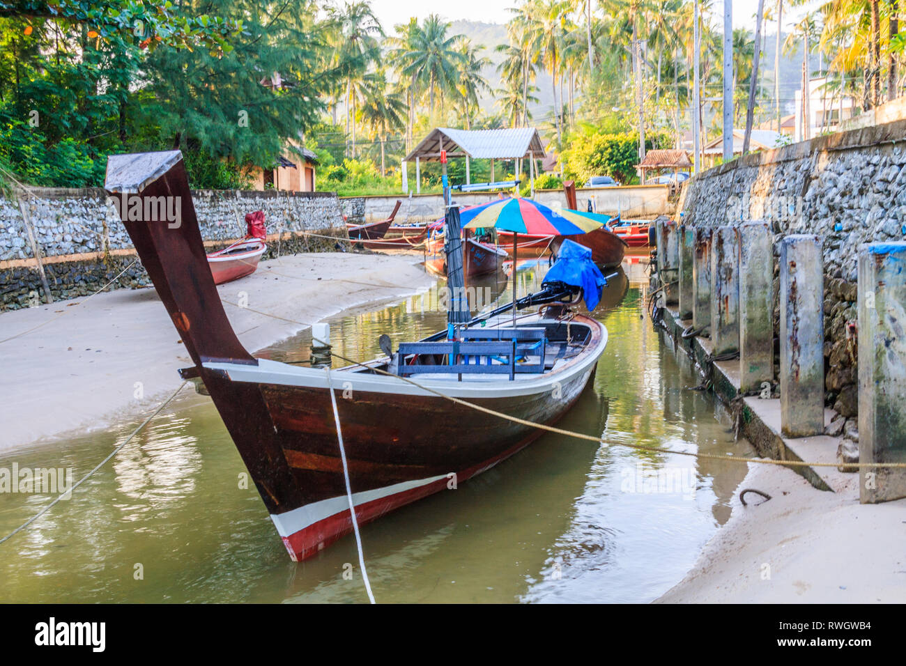 Long tail boats moored in a creek by Bang Tao beach, Phuket, Thailand Stock Photo