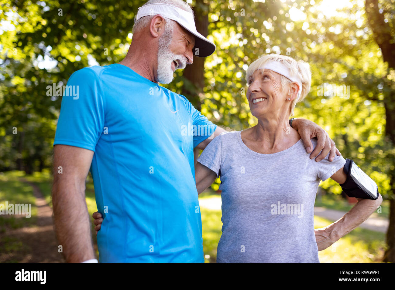 Fitness, sport and lifestyle concept - happy mature couple in sports clothes outdoors Stock Photo